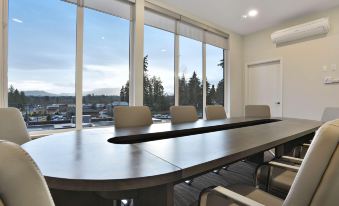 a large conference room with a long table and several chairs arranged for a meeting at Best Western Cowichan Valley Inn