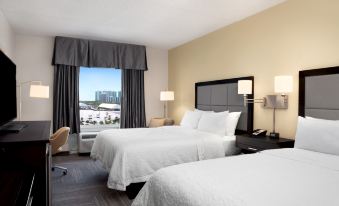 a hotel room with two beds , one on the left side of the room and the other on the right at Hampton Inn Hallandale Beach-Aventura