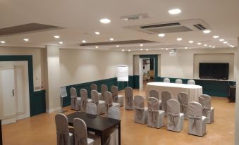 a conference room set up for a meeting , with chairs arranged in rows and a whiteboard on the wall at Smy Civico Zero