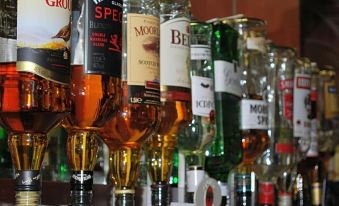 a bar with a variety of bottles on display , including vodka and other alcoholic beverages at Kincaid House Hotel