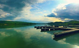 a serene landscape with a body of water and several boats docked at a pier at Nature Inn at Bald Eagle