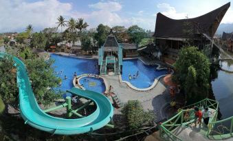 a large outdoor water park with multiple slides , pools , and play areas for children and adults at Danau Dariza Resort  - Hotel