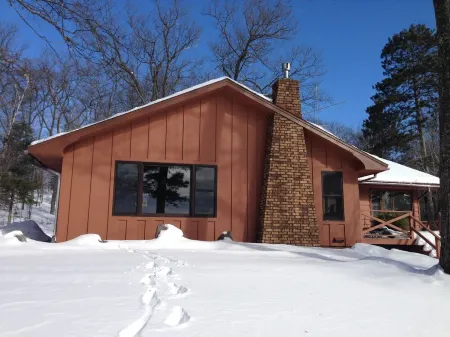 Escape to the Northwoods at this picturesque Sand Lake home