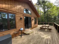 Timber cottage with large deck overlooking the water. Boat access only, no road.
