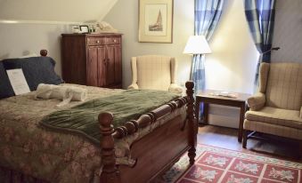 a cozy bedroom with a wooden bed , blue curtains , and a window with a view of the city at Black Swan Inn