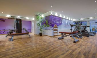 a well - equipped gym with various exercise equipment , including treadmills and weight machines , as well as a yoga studio at Park Inn by Radisson Dammam