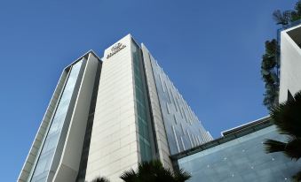 "a tall , modern building with the brand name "" hiltonia "" prominently displayed on its side" at Hilton Bandung