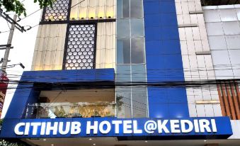 "a blue and white building with a sign that reads "" citihub hotel @ kedidi "" prominently displayed on the front" at Citihub Hotel @Kediri