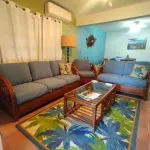 Hidden by beautiful palm and flamboyant trees but close to restaurants & stores