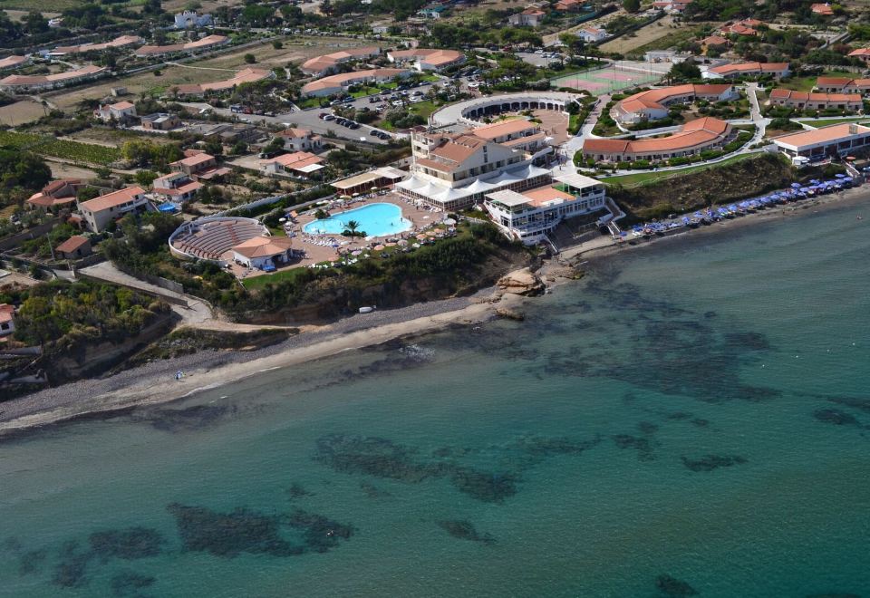 a bird 's eye view of a resort with a pool and buildings near the water at La Plage Resort