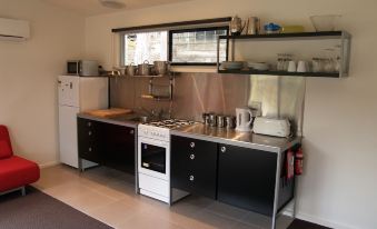 a kitchen with stainless steel appliances , including a stove and refrigerator , along with various items on the counter at Craggy Peaks