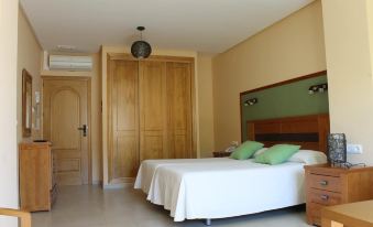 a hotel room with two beds , one on the left and one on the right side of the room at Hotel Sierra Luz