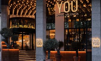 "a building with a sign that reads "" only you "" on the front , surrounded by trees" at Only You Hotel Valencia