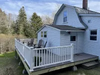 Rustic vintage cottage in Duck Cove with limited ocean view.
