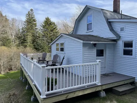 Rustic vintage cottage in Duck Cove with limited ocean view.