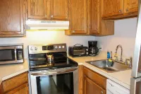 Water view condo with a pool, tennis court, fireplace, balcony & golf nearby