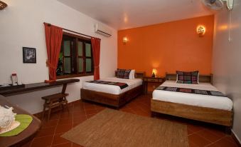 a hotel room with two beds , one on the left and one on the right side of the room at Tara Lodge Haven of Peace