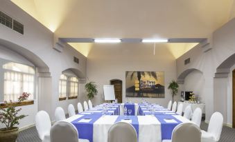 a large dining room with multiple tables and chairs , all set up for a formal event at Three Corners Rihana Resort El Gouna