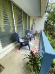 Tropical one bedroom condo steps from pool.