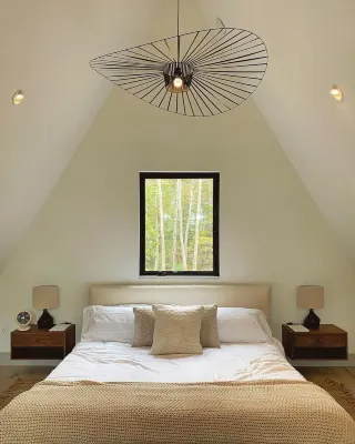 A modern A-frame, nestled in the woods with relaxing outdoor spaces and firepit.