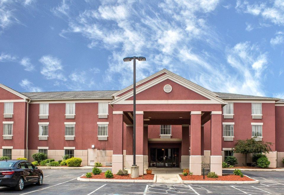 "a large red building with a sign that reads "" holiday inn express & suites "" is shown in the image" at Wingate by Wyndham Clearfield