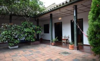 a courtyard with a brick patio and potted plants , creating a serene and inviting atmosphere at Hotel San Cristobal