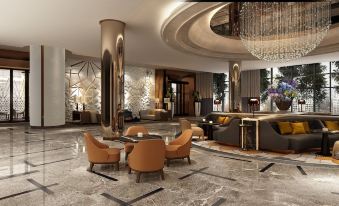 a luxurious hotel lobby with high ceilings , marble floors , and modern furniture , including chairs , tables , and a chandelier at Hilton Mall of Istanbul