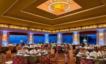 a large , well - lit dining room with multiple tables and chairs arranged for a formal event at The Westin Playa Bonita Panama