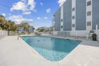 Beach Getaway - First floor unit with Pool and beach access steps away!