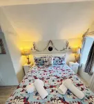 Charming  Listed Thatched Cottage with parking and short walk to sandy beach .