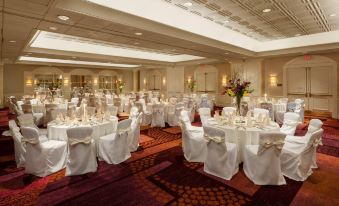 a large , well - decorated banquet hall with multiple tables set up for a formal event or a wedding reception at Crowne Plaza Englewood, an IHG Hotel