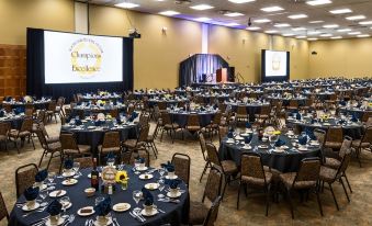 a large banquet hall with numerous tables and chairs set up for a formal event at Arrowwood Resort at Cedar Shore