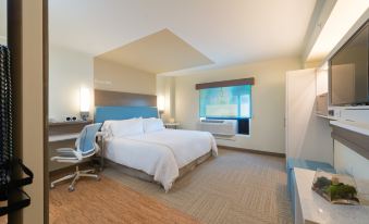 a modern hotel room with a large bed , desk , and window , providing a comfortable and spacious environment at Even Hotel Rockville - Washington, DC Area, an IHG Hotel