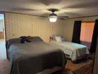 Cozi retreat set in the woods within walking distance of Waubee Lake.