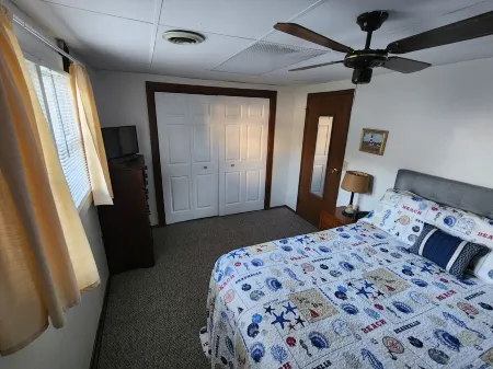 Open concept 2 bedroom ranch with attached garage and deck