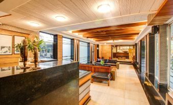 a modern office lobby with wooden ceiling , large windows , and a reception desk with seating at Le Magnifique