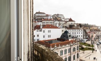 a view of a city with white buildings and red roofs , taken from a balcony at Hotel Astoria