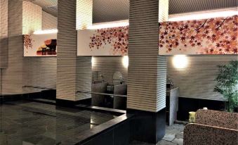 a modern and stylish indoor area with multiple benches , tables , and mirrors , surrounded by white walls and black columns at Hotel Hokke Club Hiroshima