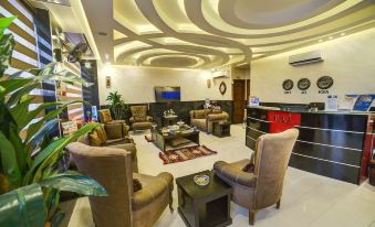 a modern lounge area with comfortable seating , including chairs and couches , and a coffee table at Taj Hotel