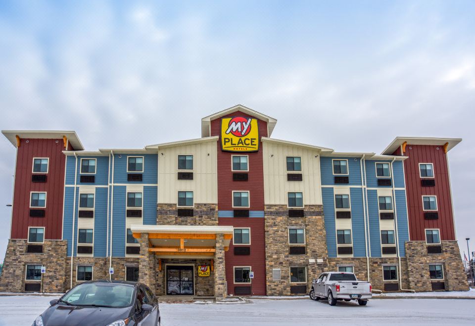an exterior view of a my place hotel with a large sign above the entrance at My Place Hotel-Shakopee, MN