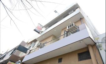 a two - story building with a balcony on the second floor and a door on the third floor at Hotel India