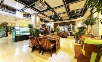 There is a restaurant in the center with tables and chairs, as well as additional seating areas at Hotel Zenith