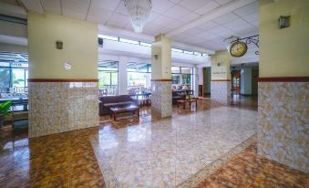 a large , empty room with tiled floors and walls , where a dining table and chairs are arranged for a meal at Hotel la Riviera de Atitlán