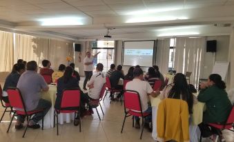 a group of people gathered in a room , with some of them standing and others sitting at Brotas Eco Hotel Fazenda