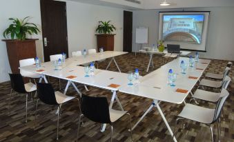 a conference room set up for a meeting , with chairs arranged in a semicircle around a long table at The Fortress Resort and Spa