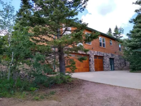 Location!  Nice log home in dark sky community next to several peaks