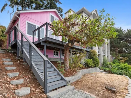 Darling pink beach house with epic views in a cozy community.