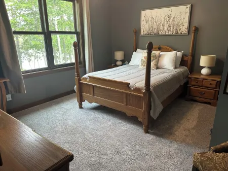 BEAUTIFUL lake front home with a private beach, dock and large yard