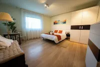 Villa in the mountains in front of a lake.