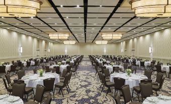 a large , empty conference room with multiple round tables and chairs set up for a meeting or event at Delta Hotels by Marriott Baltimore Hunt Valley